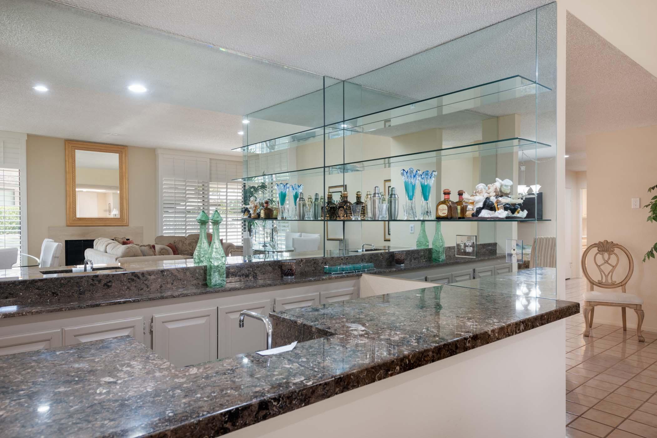 8 Tulane Court Rancho Mirage, CA 92270 - Photo 24 of 31 a kitchen with counter top space a sink and cabinets