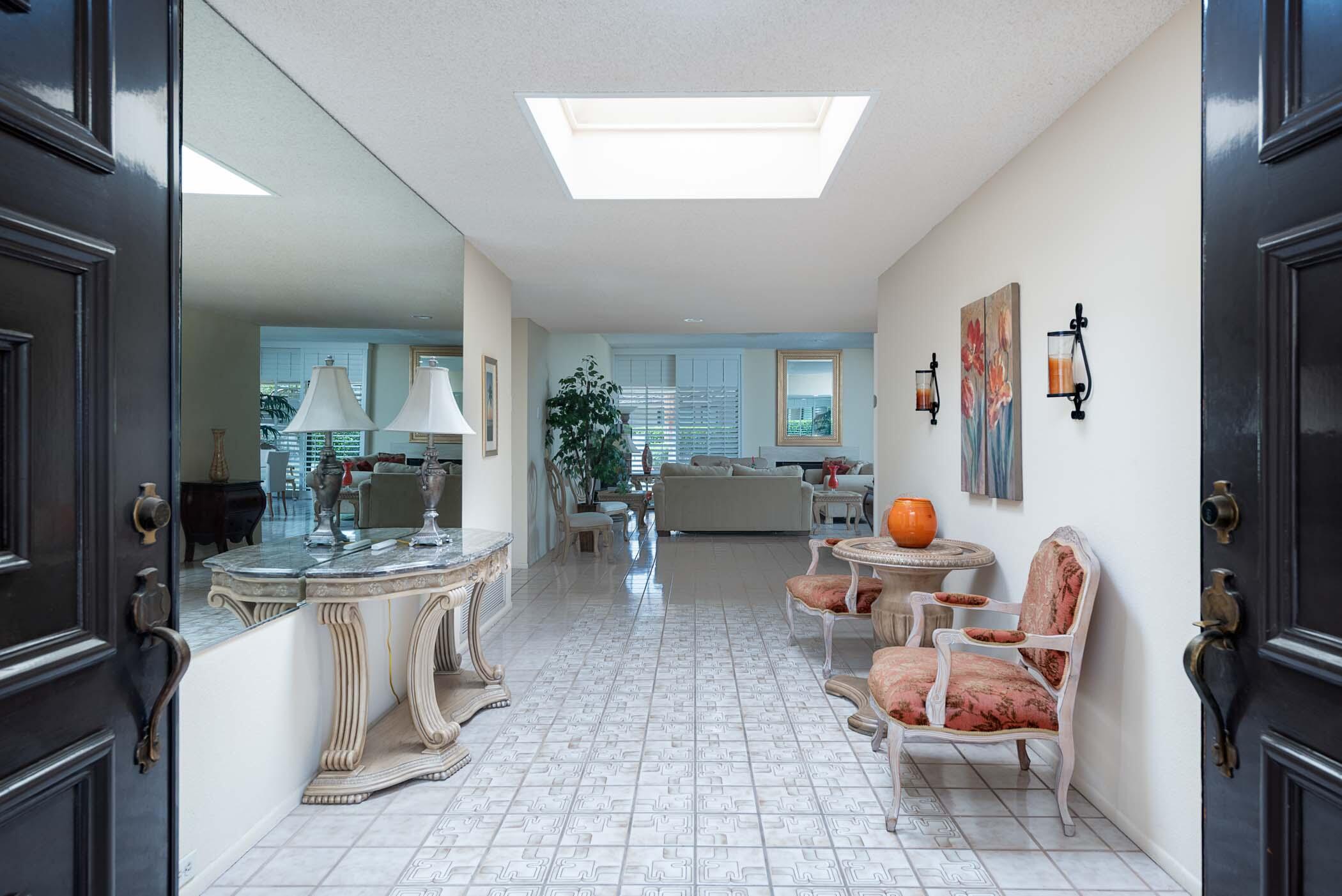 8 Tulane Court Rancho Mirage, CA 92270 - Photo 4 of 31 a living room with fireplace furniture and a potted plant