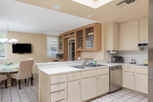 a kitchen with a sink cabinets and window