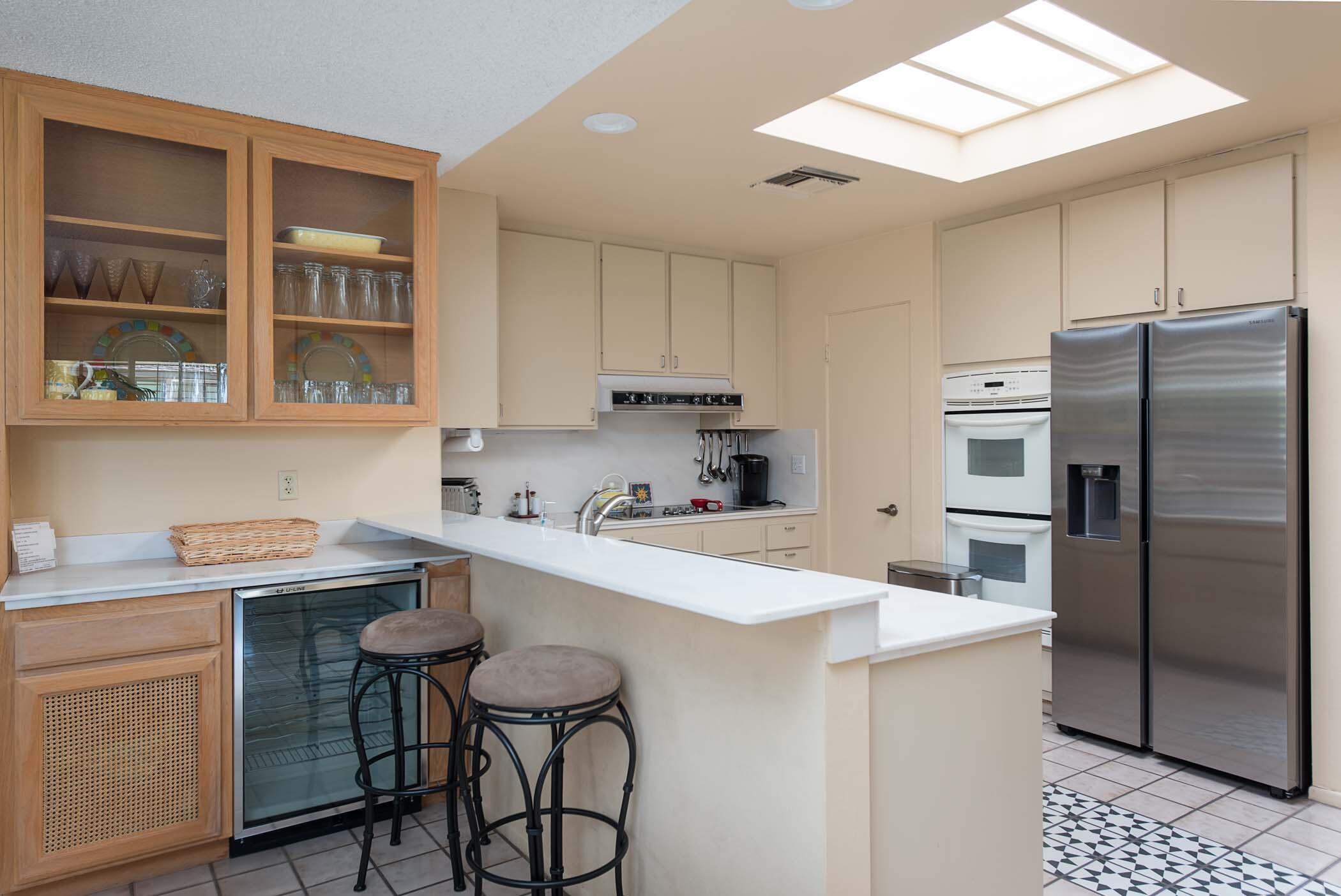 8 Tulane Court Rancho Mirage, CA 92270 - Photo 8 of 31 a kitchen with a sink a counter space stainless steel appliances cabinets and a window