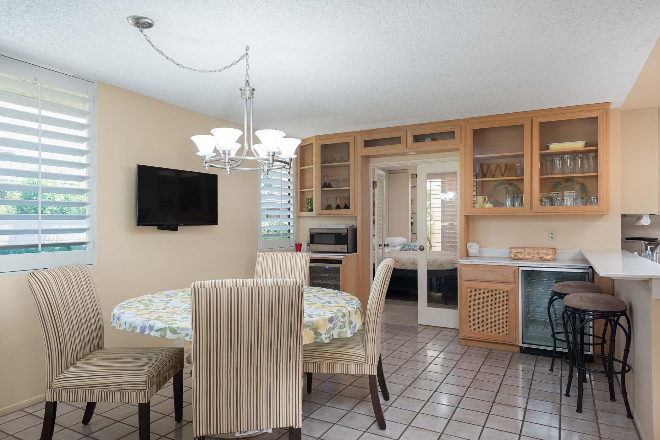 8 Tulane Court Rancho Mirage, CA 92270 - Photo 9 of 31 a living room with furniture a flat screen tv and kitchen view