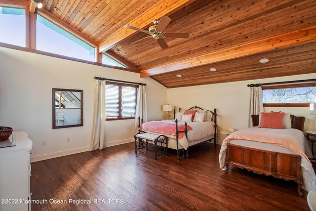 a spacious bathroom with a toilet a sink and a large mirror