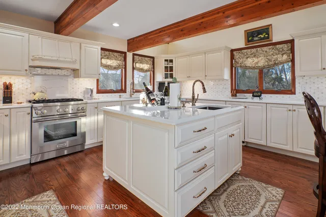 a view of a dining hall with couches a flat tv screen and couches with wooden floor