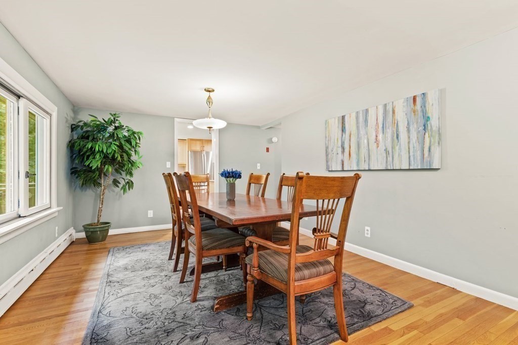 7 Flagg Road Acton, MA 01720 - Photo 13 of 39 a dining room with furniture a rug and a chandelier