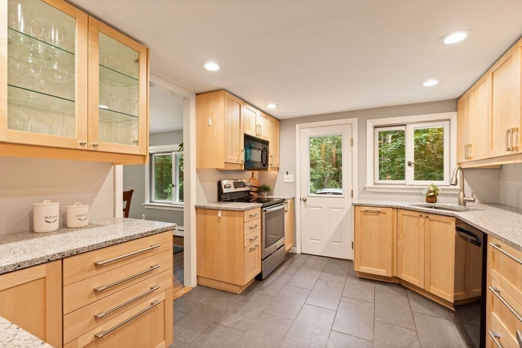 7 Flagg Road Acton, MA 01720 - Photo 15 of 39 a kitchen with granite countertop white cabinets and white appliances