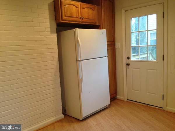 911 Robin Road Silver Spring, MD 20901 - Photo 3 of 15 a white refrigerator freezer sitting in a kitchen