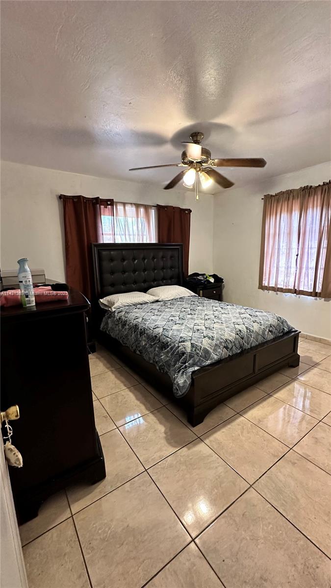 3077 Southwest 5th Street Miami, FL 33135 - Photo 11 of 28 a bedroom with a bed and a chandelier