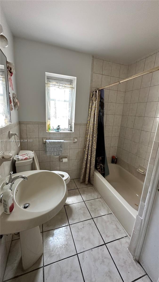 3077 Southwest 5th Street Miami, FL 33135 - Photo 13 of 28 a bathroom with a sink a toilet and shower