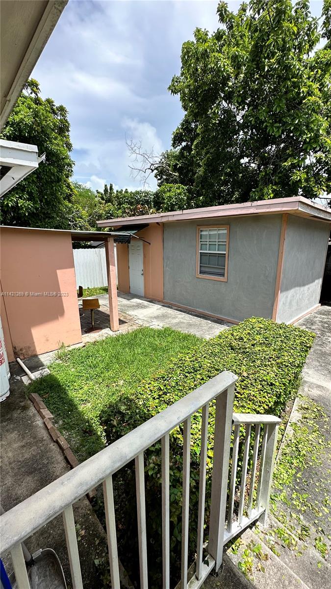 3077 Southwest 5th Street Miami, FL 33135 - Photo 20 of 28 a front view of a house with a yard