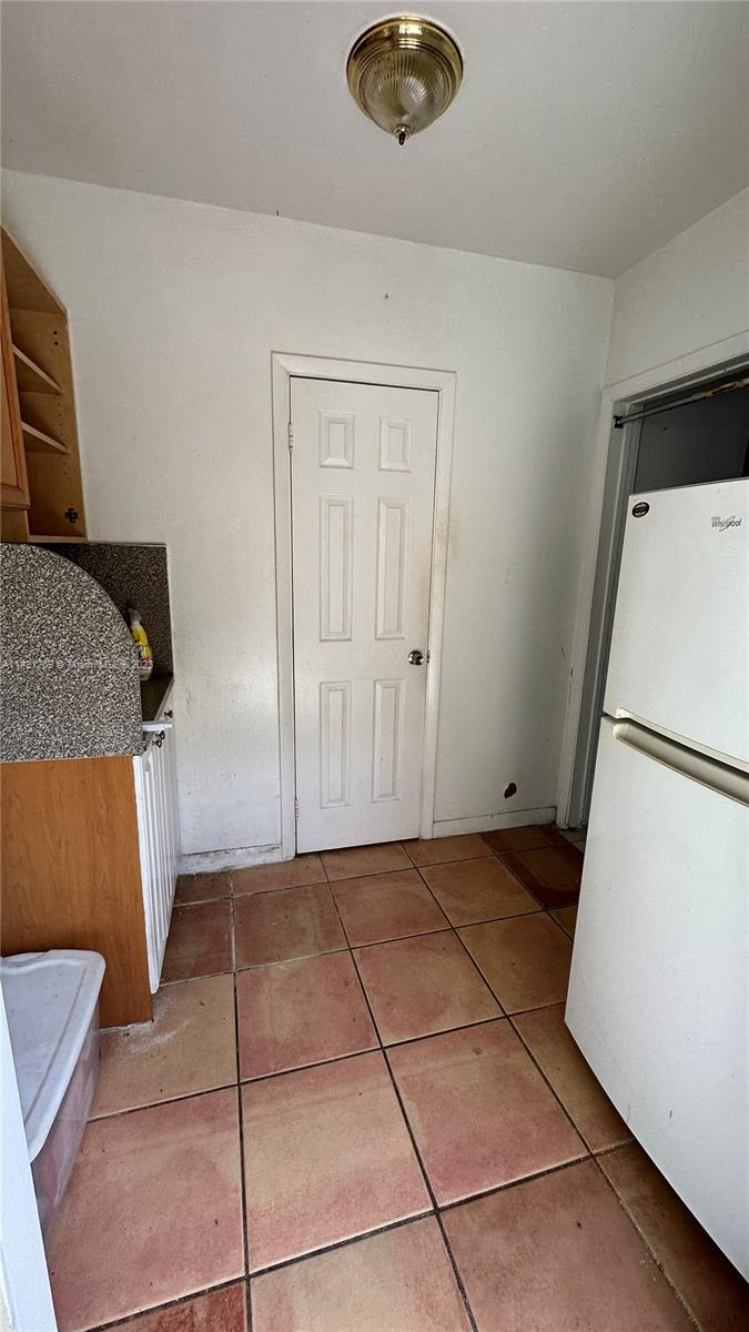 3077 Southwest 5th Street Miami, FL 33135 - Photo 23 of 28 a view of a storage & utility room with a refrigerator