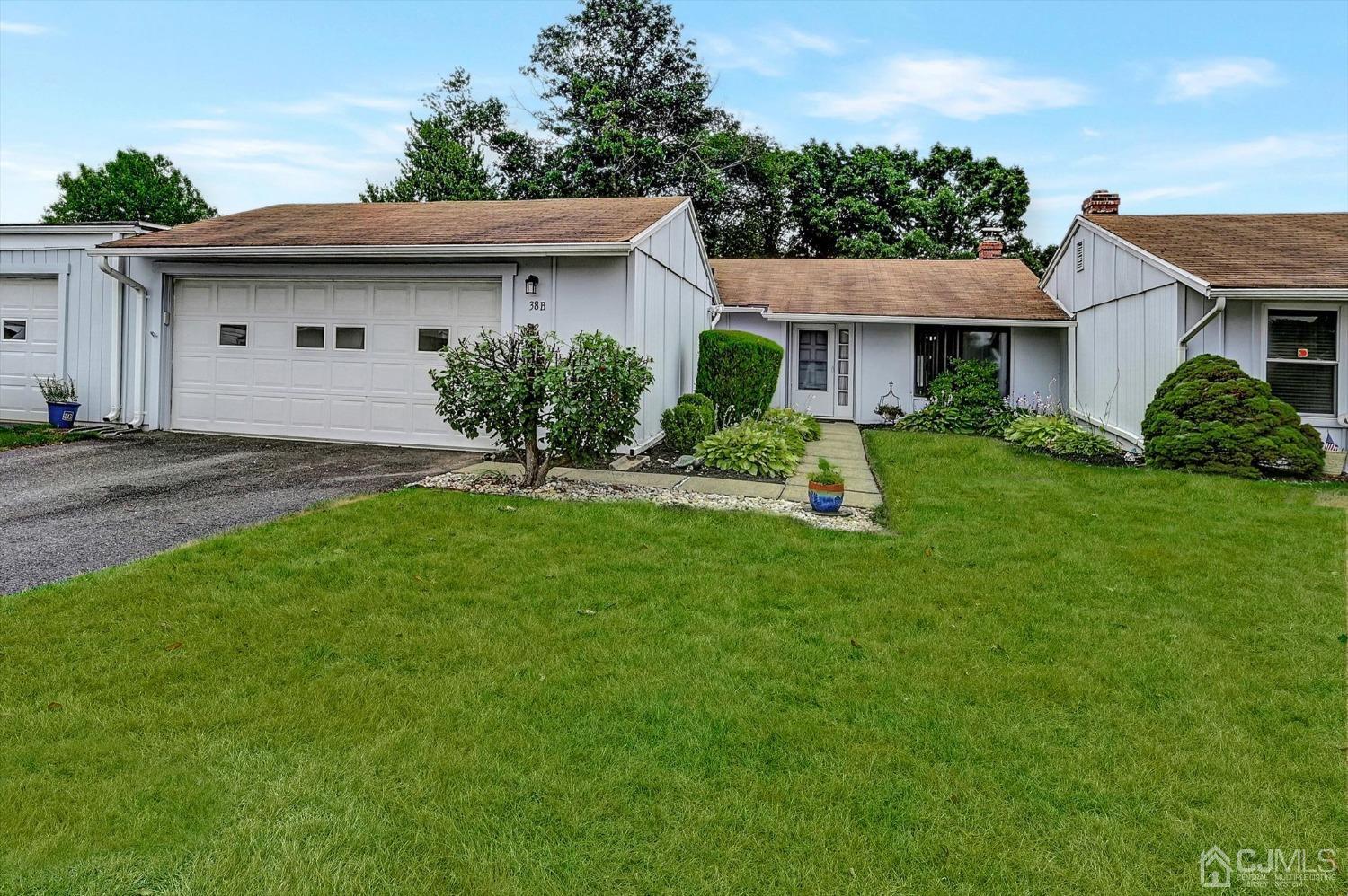 B Haddon Road Monroe Township, NJ 08831 - Photo 1 of 34 a front view of a house with a garden