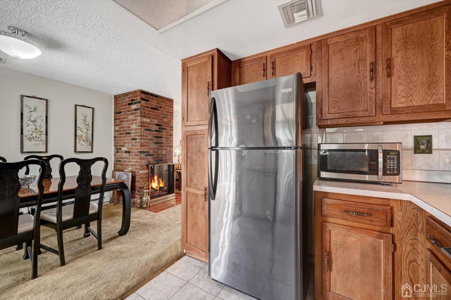 B Haddon Road Monroe Township, NJ 08831 - Photo 11 of 34 a kitchen with stainless steel appliances granite countertop a refrigerator a stove and a sink with wooden cabinets
