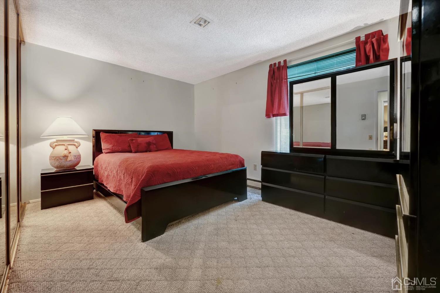 B Haddon Road Monroe Township, NJ 08831 - Photo 16 of 34 a bedroom with a bed and a dresser