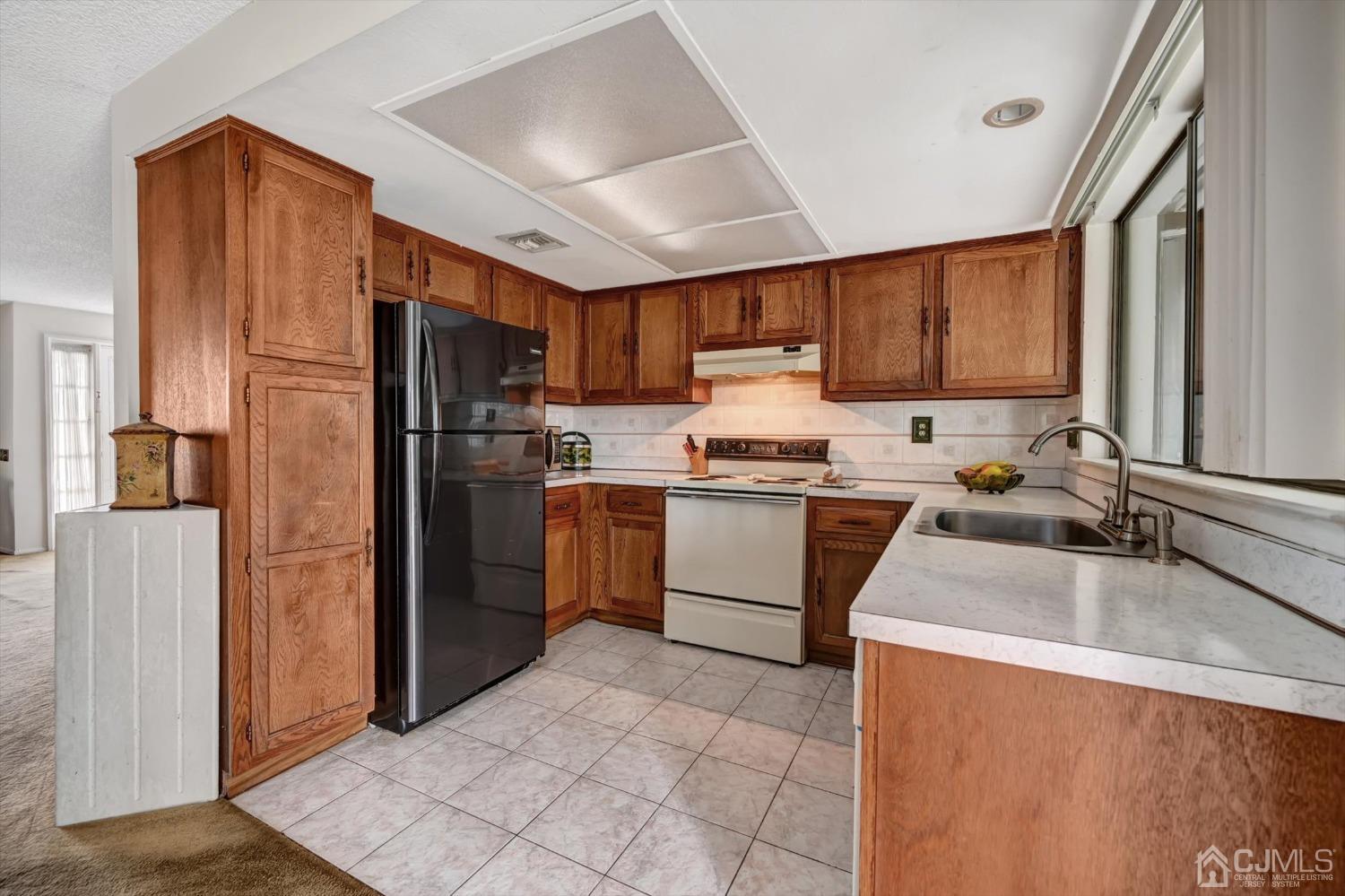 B Haddon Road Monroe Township, NJ 08831 - Photo 8 of 34 a kitchen with a refrigerator sink and cabinets