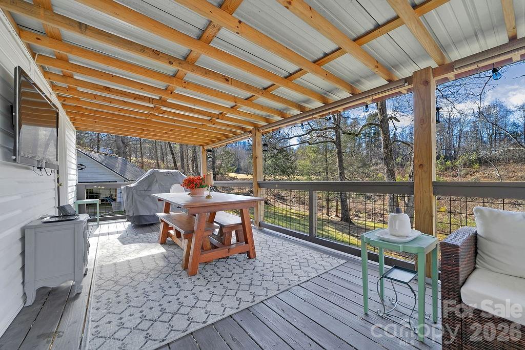 50 Illahee Point Brevard, NC 28712 - Photo 24 of 37 a outdoor space with the couches and dining table with the garden view