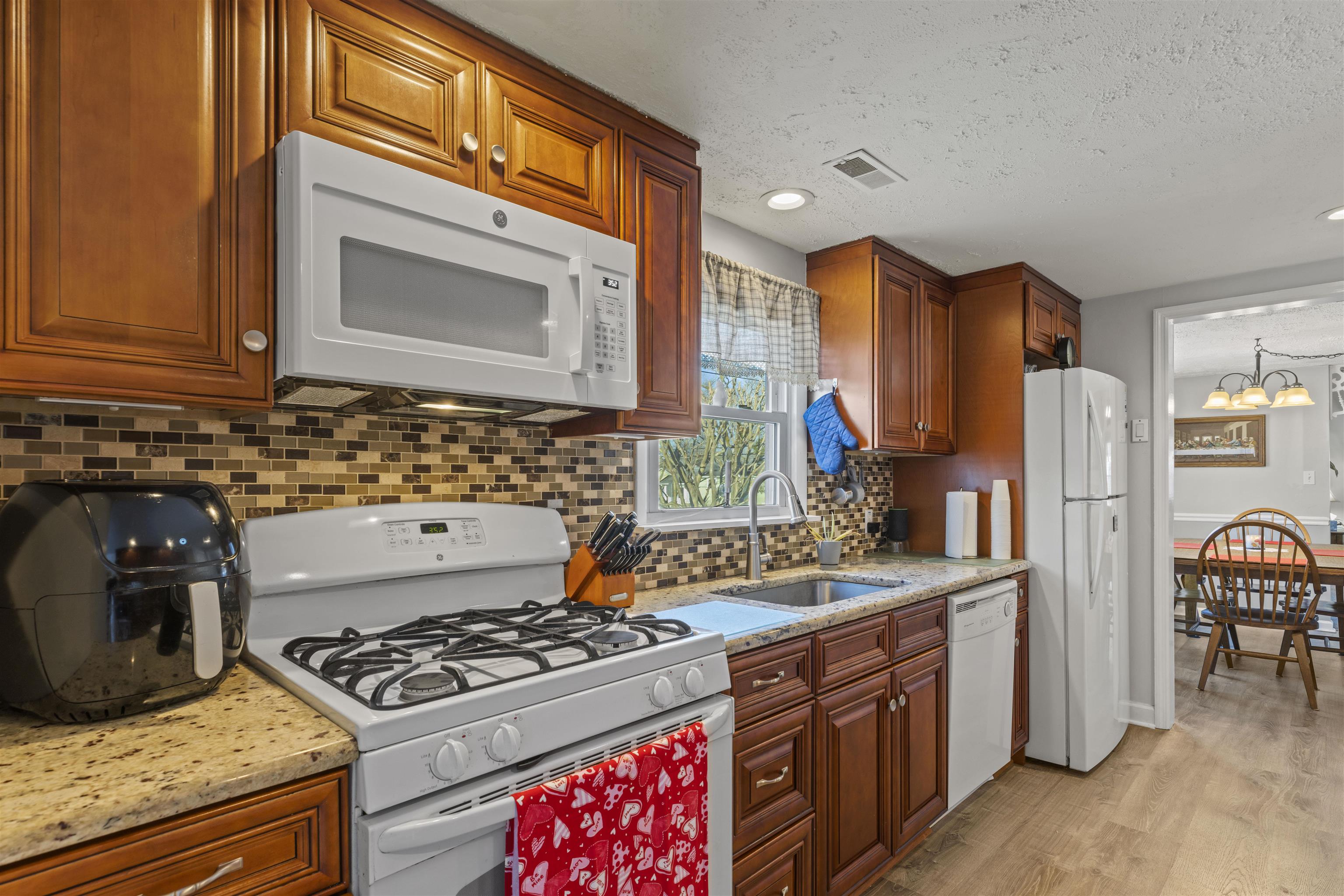 112 East Drumbed Road Villas, NJ 08251 - Photo 7 of 42 a kitchen with stainless steel appliances granite countertop a stove a sink and a refrigerator