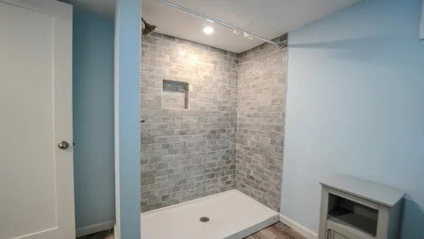 a view of a hallway with wooden floor and staircase