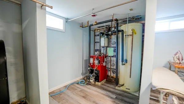 a view of a house with backyard and sitting area