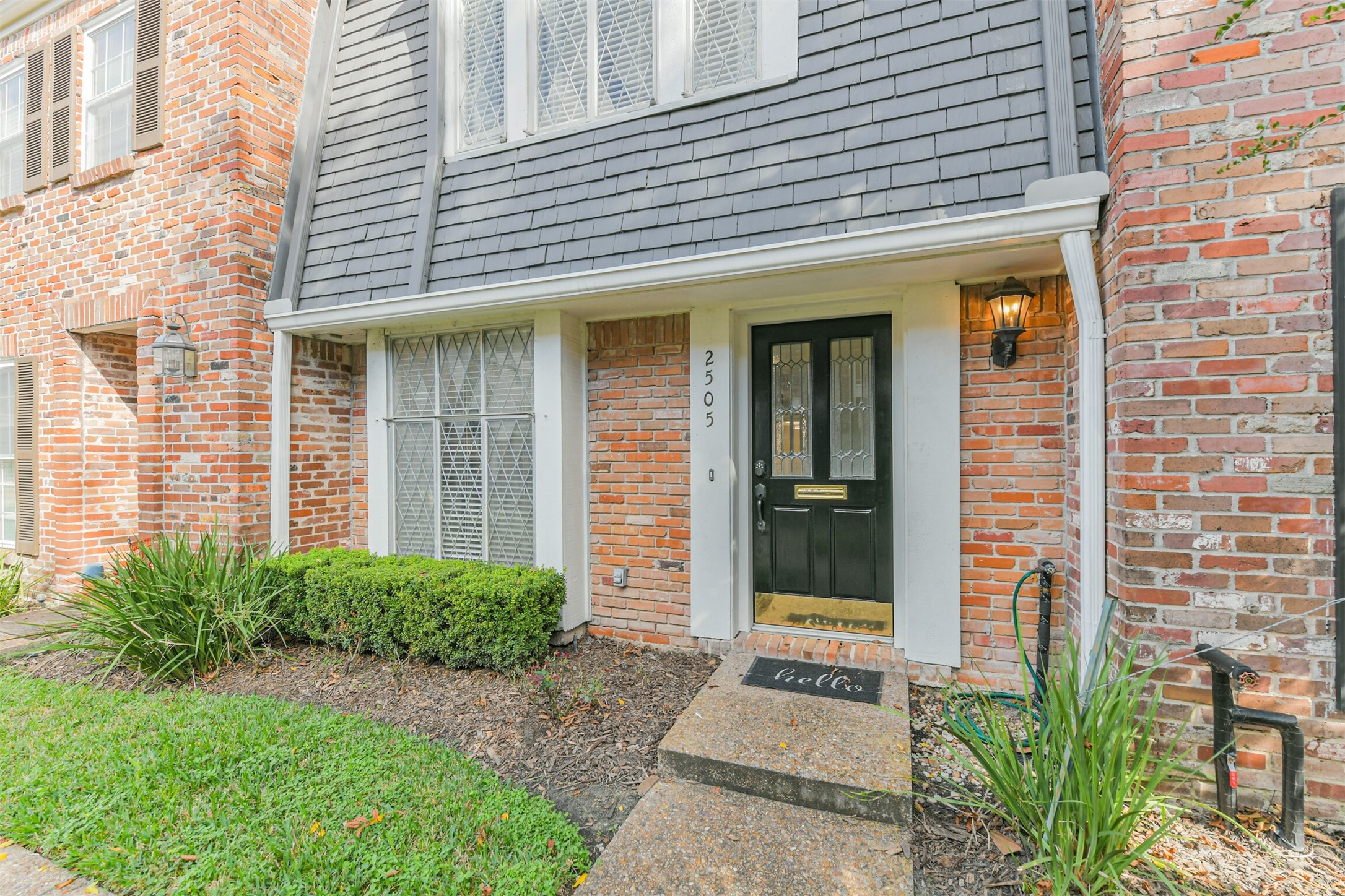 a front view of a brick house with a large windows