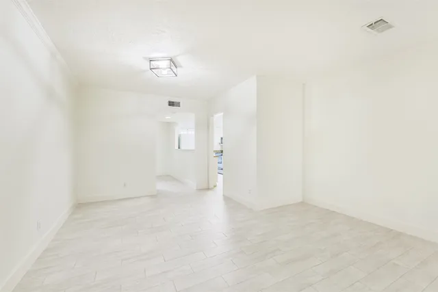 an empty room with a kitchen