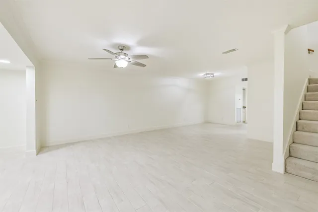 an empty room with fan and a ceiling fan