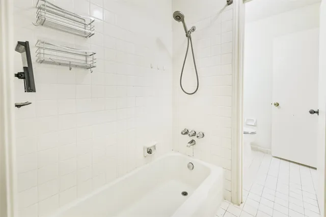 a bathroom with a bath tub with a shower