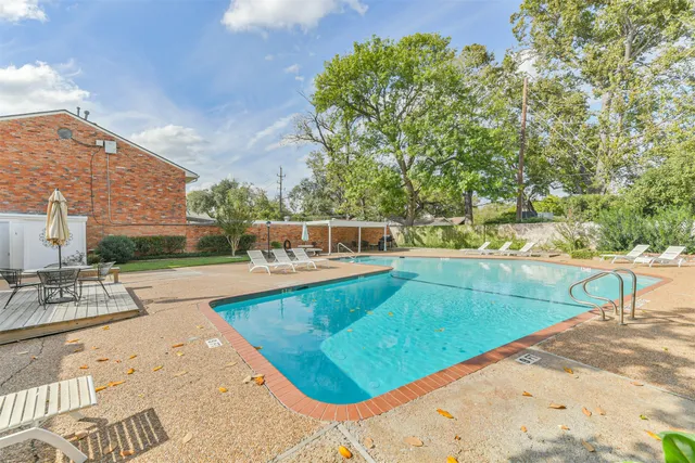 a view of a swimming pool with a lounge chair
