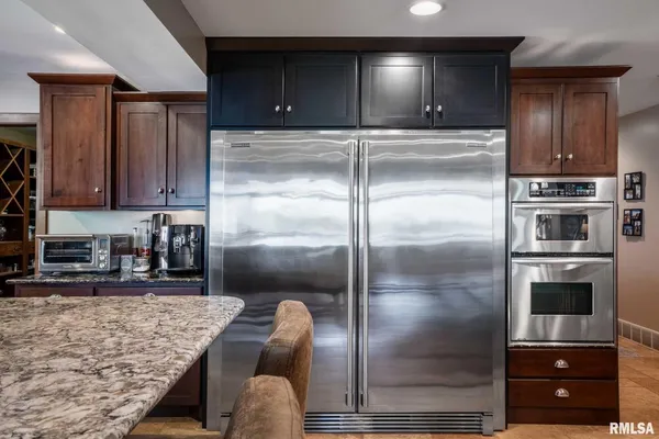 a kitchen with a sink a refrigerator and a stove