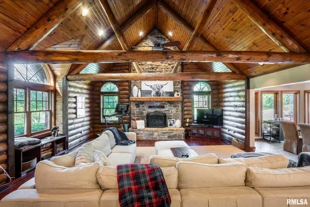 a living room with furniture a fireplace and a flat screen tv