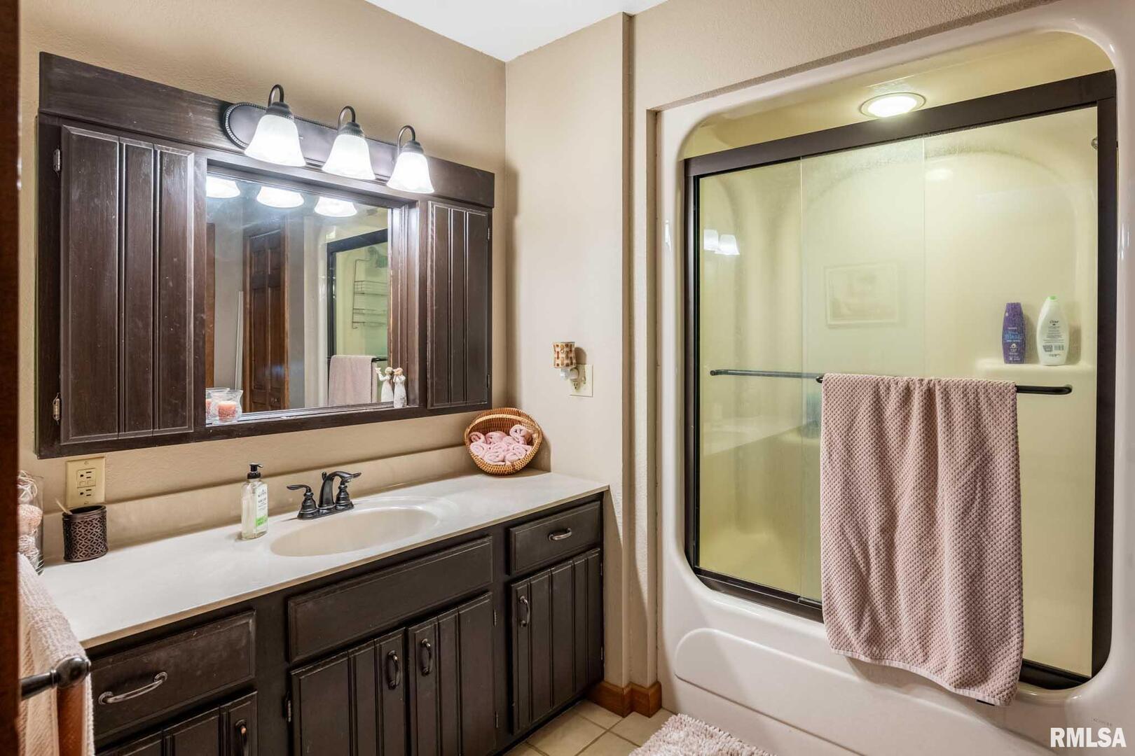 2145 Lick Creek Road Anna, IL 62906 - Photo 31 of 64 a bathroom with a double vanity sink and a mirror