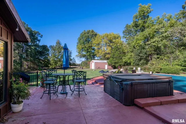 a view of patio with a table and chairs under an umbrella