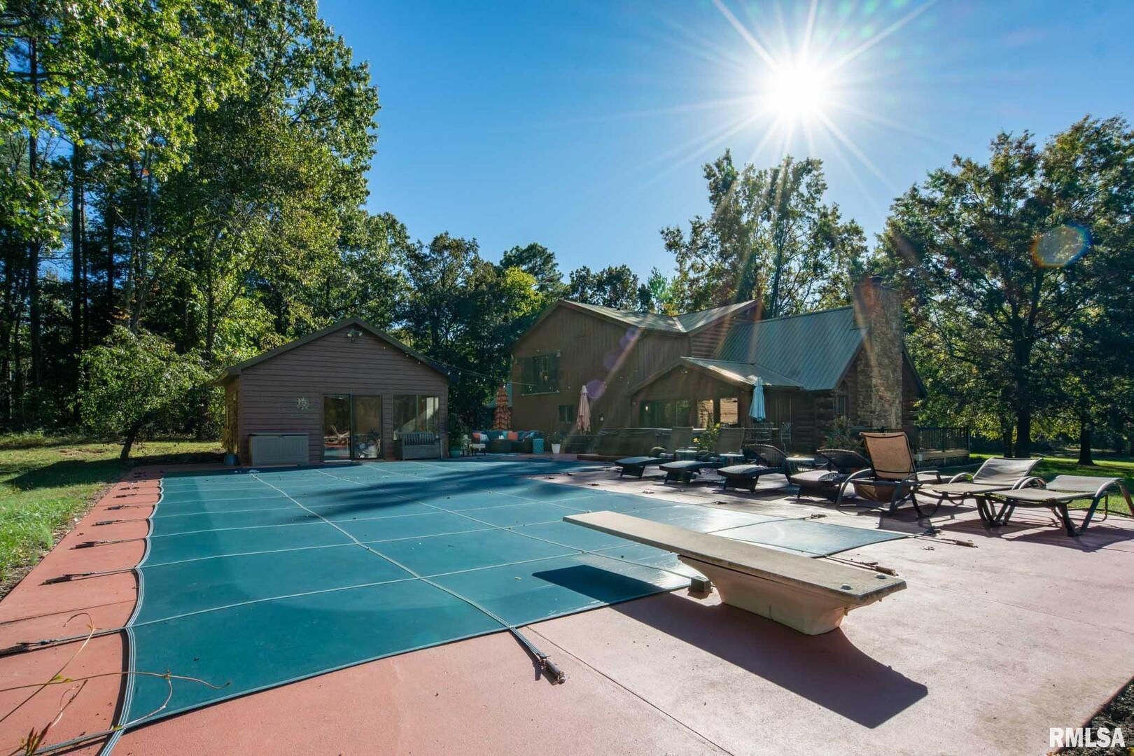 2145 Lick Creek Road Anna, IL 62906 - Photo 41 of 64 a view of patio with a table and chairs under an umbrella