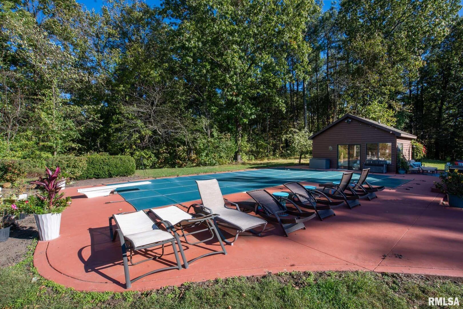 2145 Lick Creek Road Anna, IL 62906 - Photo 42 of 64 a backyard of a house with table and chairs