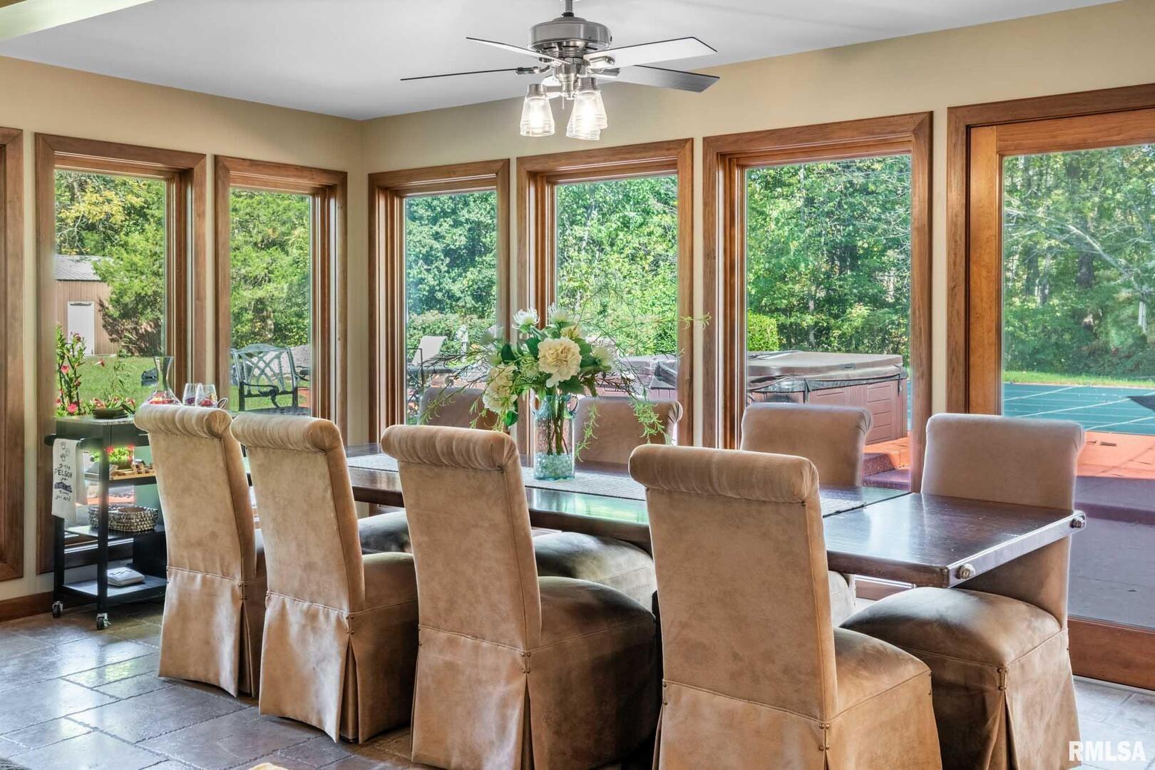 2145 Lick Creek Road Anna, IL 62906 - Photo 8 of 64 a view of a dining room with furniture large windows and wooden floor