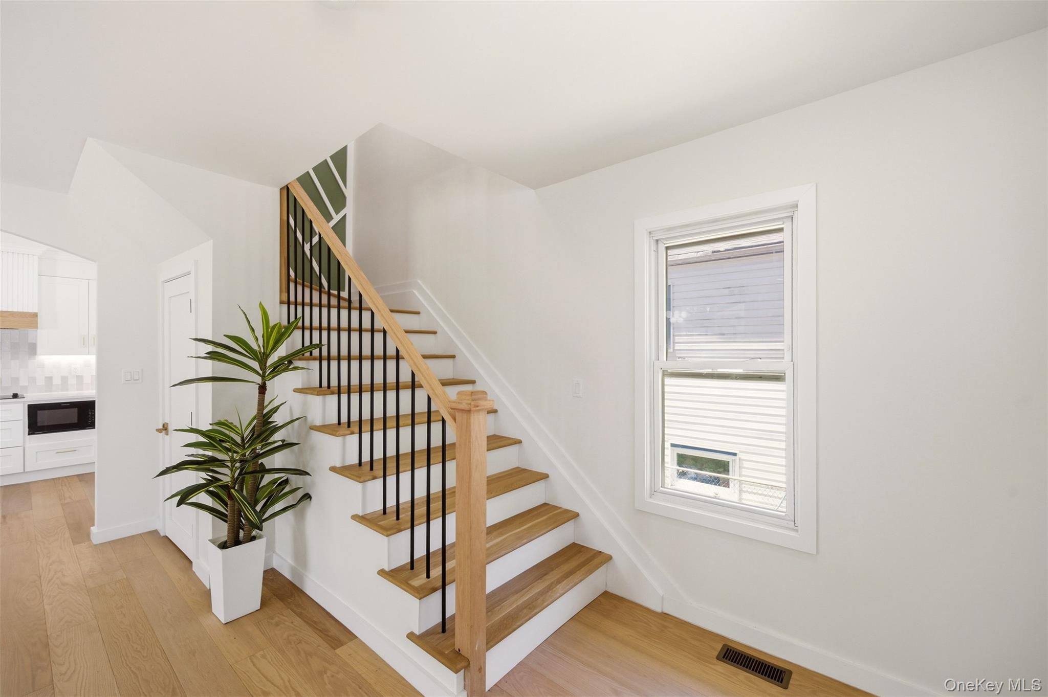 135 Whaley Street Freeport, NY 11520 - Photo 8 of 38 a view of entryway with wooden floor