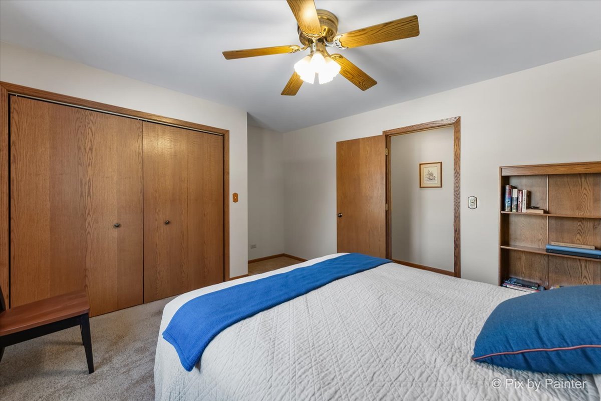 4507 Hanover Drive Crystal Lake, IL 60012 - Photo 19 of 63 a bedroom with a bed and a chandelier