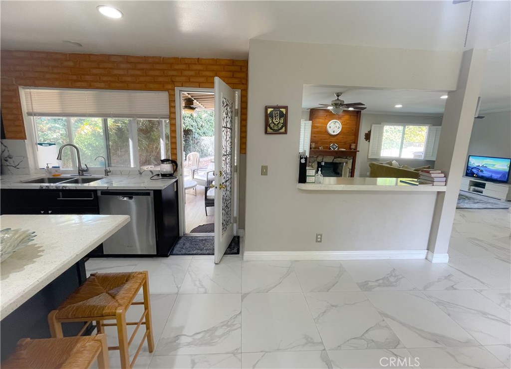 20311 Flintgate Drive Walnut, CA 91789 - Photo 7 of 32 a view of a kitchen with kitchen island granite countertop wooden floor and a view of living room