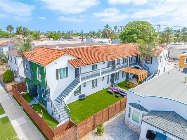 a aerial view of a house with balcony and trees al around