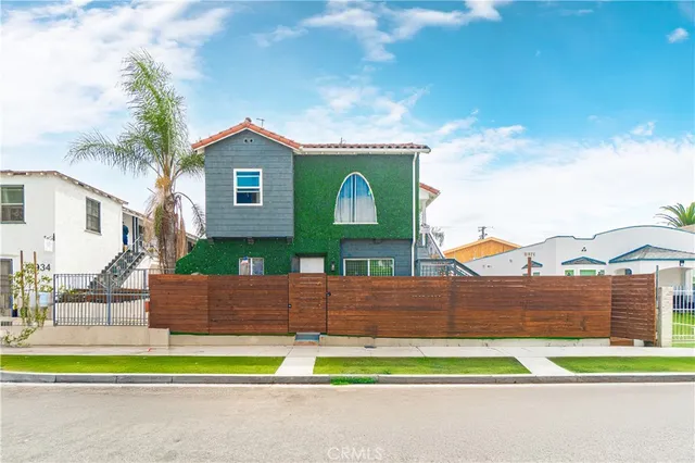 a view of a house with a yard and sitting area