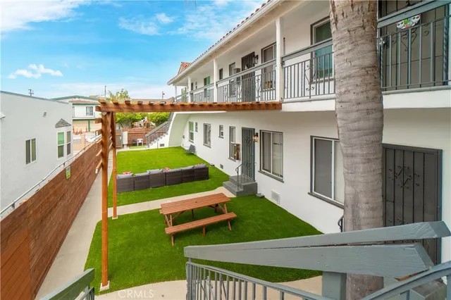 a backyard of a house with table and chairs