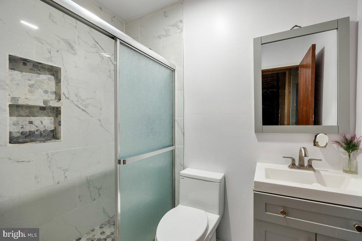 8275 Maple Avenue Pennsauken, NJ 08109 - Photo 16 of 43 a bathroom with a toilet sink and shower