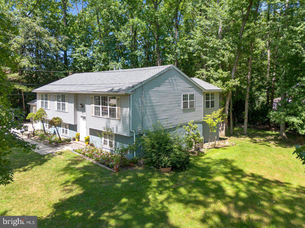 8275 Maple Avenue Pennsauken, NJ 08109 - Photo 20 of 43 a front view of a house with a yard table and chairs