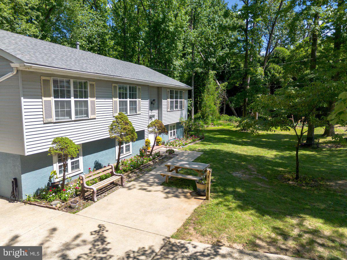8275 Maple Avenue Pennsauken, NJ 08109 - Photo 31 of 43 a view of backyard with table and chairs and wooden fence