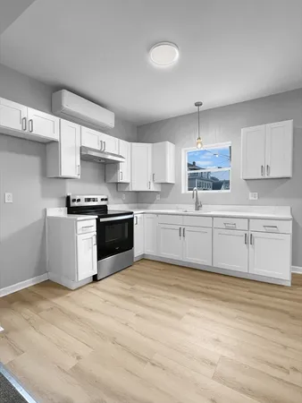 a kitchen with stainless steel appliances cabinets a sink and a stove