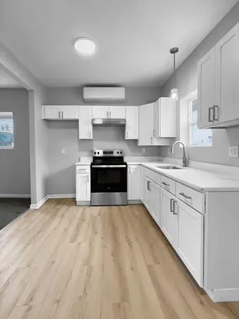 a kitchen with kitchen island granite countertop a sink stainless steel appliances and cabinets