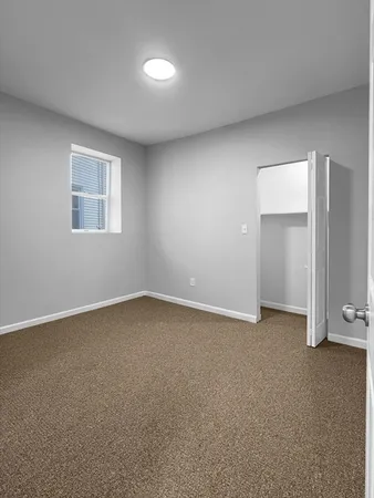 an empty room with a empty space and window