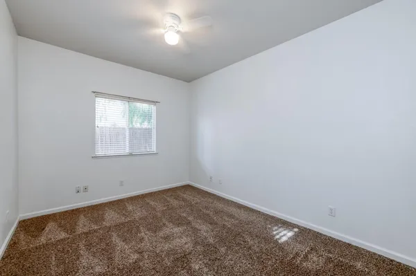 an empty room with a empty space and windows