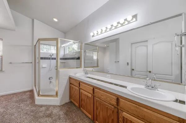 a bathroom with a double vanity sink and a mirror