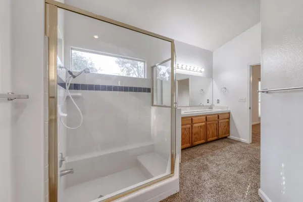 a bathroom with a tub a sink and a mirror