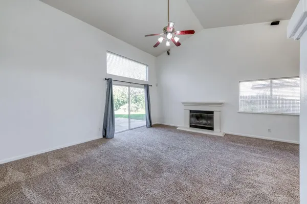 a view of an empty room with a fireplace